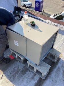 A new rooftop HVAC unit being installed or serviced on concrete blocks by Service Champions Heating & Cooling in Aurora, IL.