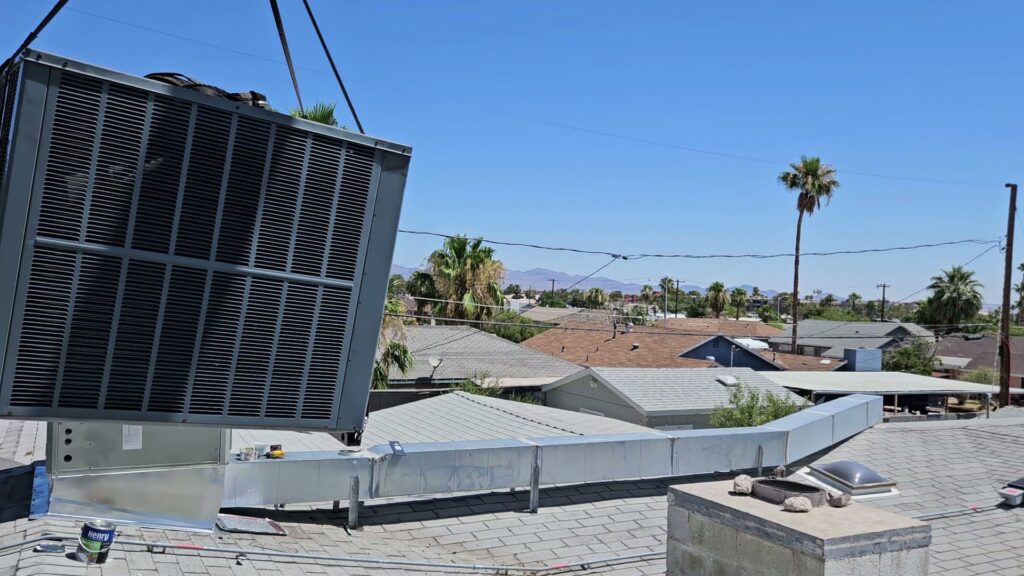 A large rooftop HVAC unit being installed and connected to ductwork by Tanana Air Conditioning & Heating in Las Vegas, NV.