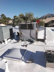 A large rooftop HVAC unit being installed or serviced by Heating & Air Paramedics - Tucson in Tucson, AZ.