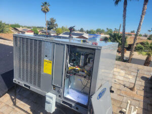 A rooftop HVAC unit with an open panel during maintenance by Az AC and Heat Services in Queen Creek, AZ.