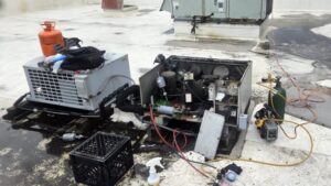 Rooftop HVAC units undergoing maintenance by Will Power Refrigeration Co, your contractor in Yonkers, NY.