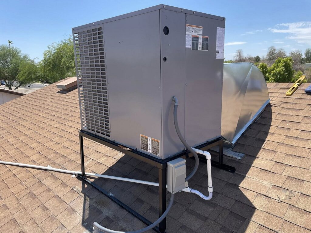A new rooftop HVAC unit installed on a metal stand with ductwork by Klee's Climate Control in Mesa, AZ.