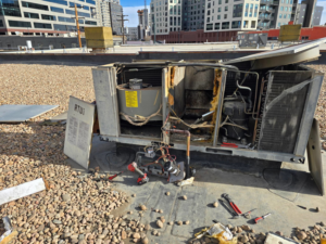 A rooftop HVAC unit undergoing repair by Proctor Mechanical & Refrigeration in West Des Moines, IA.