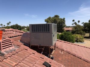 A rooftop HVAC unit installed on a tiled roof, ready for service by Hellerud Air in Peoria, AZ.