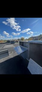 A rooftop HVAC unit with open panels showing filters and internal components during service by Buckeye Mechanical Construction in Columbus, OH.