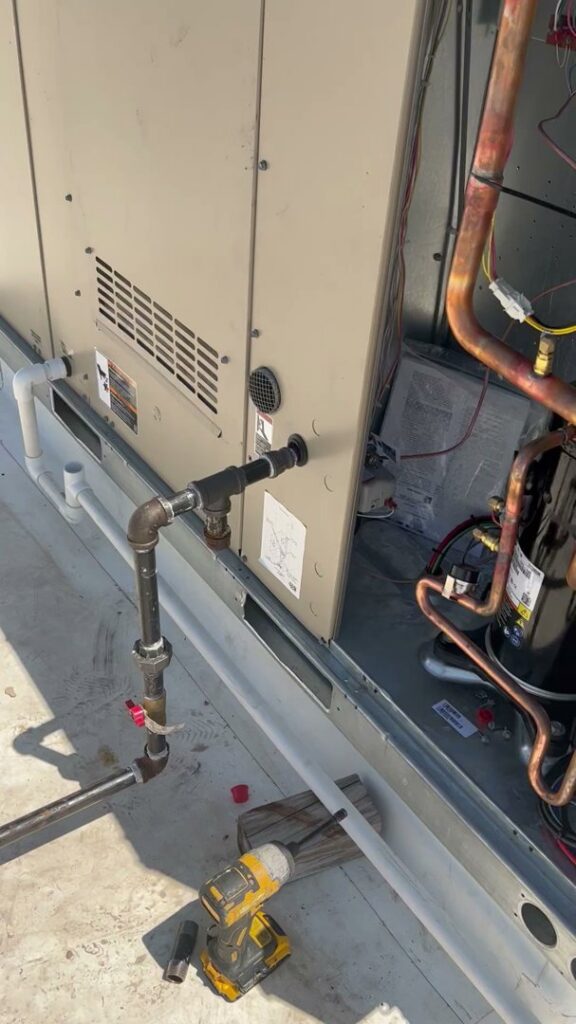 A commercial rooftop HVAC unit undergoing service and repair by Trinity Climate Control in Clayton, NC.