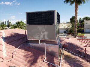A rooftop HVAC unit installed on a red tile roof by Dynamic Heating, Cooling, Refrigeration & Roofing in El Paso, TX.