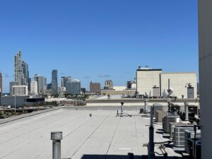 Rooftop HVAC units with a city skyline view, showcasing commercial HVAC work by Etek Refrigeration Heating and Cooling, Inc. in Chicago, IL.