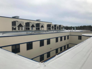 Multiple large rooftop HVAC units installed on a commercial building by RTH Mechanical Contractors in Dover, NH.