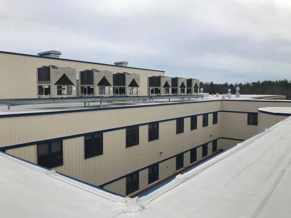 Multiple large rooftop HVAC units installed on a commercial building by RTH Mechanical Contractors in Dover, NH.