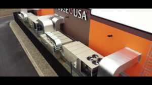 Multiple large rooftop HVAC units and extensive ductwork installed on a commercial building by Carey's Small Arms Range Ventilation in Tinley Park, IL.