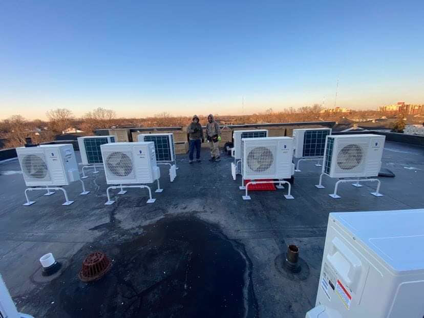 Multiple outdoor HVAC units being installed on a commercial rooftop by Embassy Heating and Air Conditioning in Toledo, OH