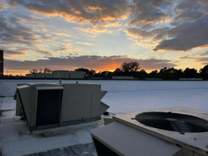 Rooftop HVAC units at sunset, showcasing commercial AC services by Comfy Cool HVACR in Newport News, VA.