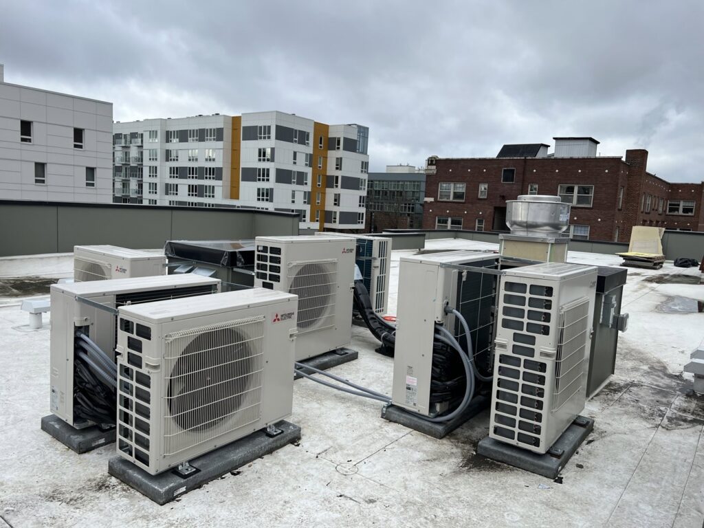 Multiple Mitsubishi Electric outdoor HVAC units installed on a commercial rooftop by Climate Control Experts HVAC LLC in Federal Way, WA