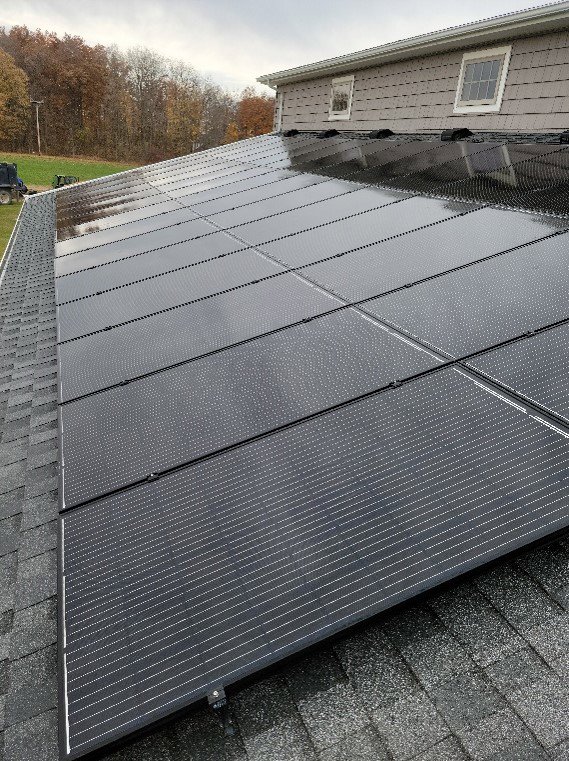 Rooftop solar panels installed on a residential building by All Circuit Electrical LLC, providing clean energy in Bryant, IN.