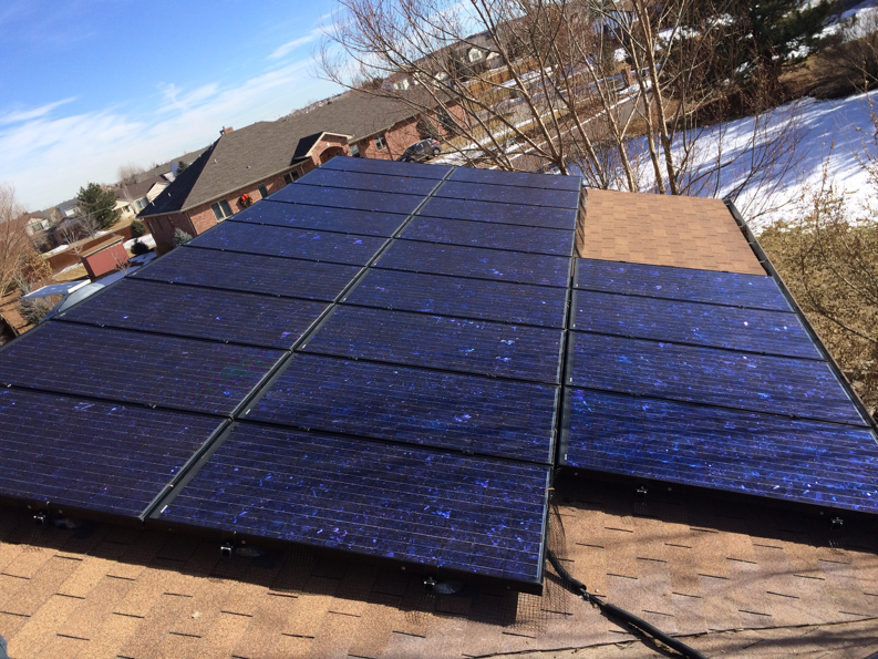 Rooftop solar panels installed on a residential home by Watts Happening Electric in Lakewood, CO.