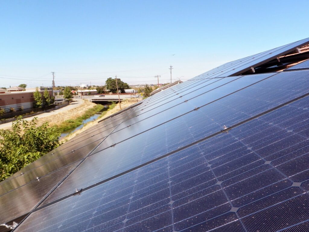 Rooftop solar panels with an urban background installed by Element Power Systems, Inc. in Brentwood, CA