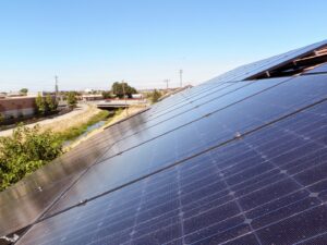 Rooftop solar panels with an urban background installed by Element Power Systems, Inc. in Brentwood, CA