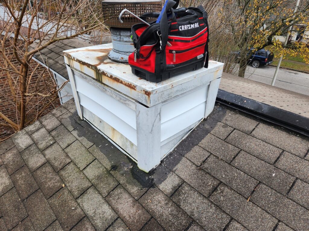 A toolbox on a rooftop next to a chimney structure, indicating wildlife exclusion or repair work by S-Tier Wildlife Control LLC in Lexington, KY.