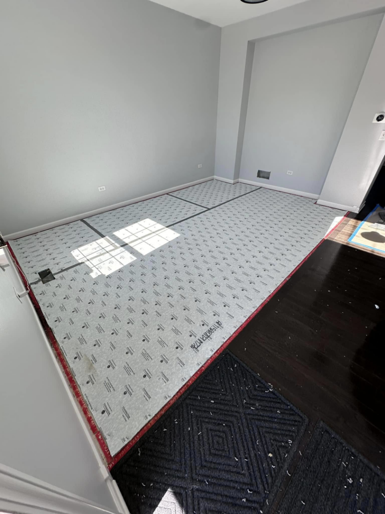 A room with carpet underlayment laid out for installation by J&A Flooring Masters Corp. in Joliet, IL.