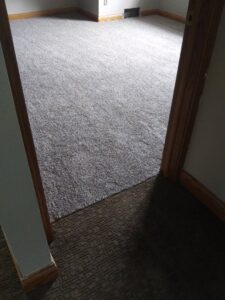 A room featuring a professional dark grey carpet installation by Floors By Roberts in Appleton, WI.