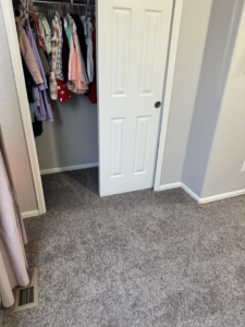 A room featuring new grey carpet, professionally installed by Cruz Carpet / Vidal Cruz in Colorado Springs, CO