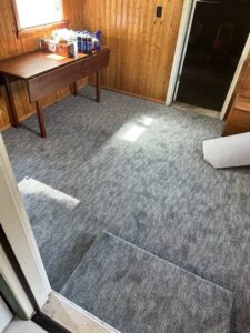 A room featuring newly installed grey carpet by PerfectStep Flooring Solutions in Rochester, NY.