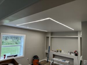 A room showcasing recessed linear LED lighting installed by Intel-electric in Anchorage, AK