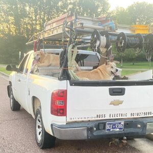 A Ross Electric Company work truck with ladders and spools of electrical wire, ready for service in Arlington, TN.