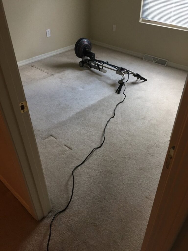 A rotary carpet cleaning machine in action, showing cleaned and uncleaned carpet by C&C Carpet Care LLC in Columbia, MO.