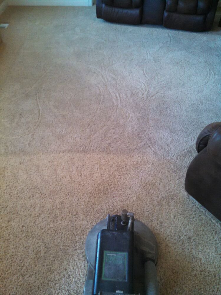 A rotary carpet cleaning machine actively cleaning a light-colored carpet by Carpet Clean Team in Meridian, ID.