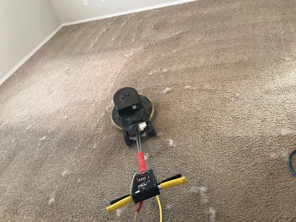 A rotary carpet cleaning machine actively cleaning a light brown carpet by Kung Fu Carpets and Cleaning Co., Meridian, ID.