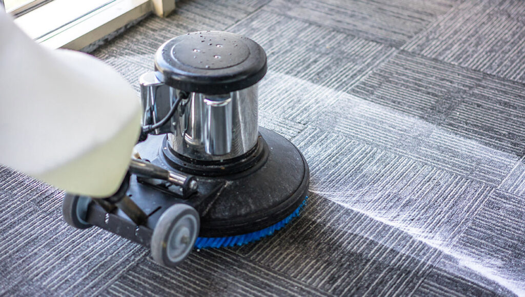A rotary carpet scrubber actively cleaning a patterned carpet, showing a clean path, by Fantastic Carpet Cleaning NYC in Ridgewood, NY