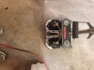 A Rotovac machine cleaning carpet, showing a clear line between cleaned and uncleaned areas by All Steamed Up Carpet/Upholstery Cleaning in Havana, FL