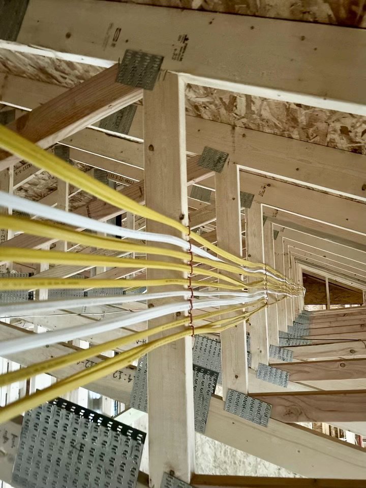 Rough-in electrical wiring installed through ceiling joists during construction by P.H. Electric in Soulsbyville, CA.