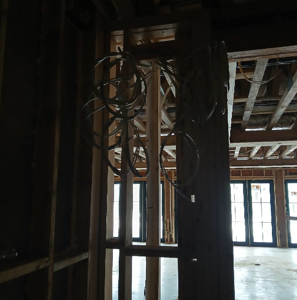 Essential Electric LLC installing rough-in electrical wiring in a framed wall during a project in Lancaster, KY.