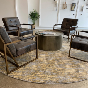 A stylish round area rug complementing lounge seating in a commercial space by CC&S Flooring in Salt Lake City, UT.