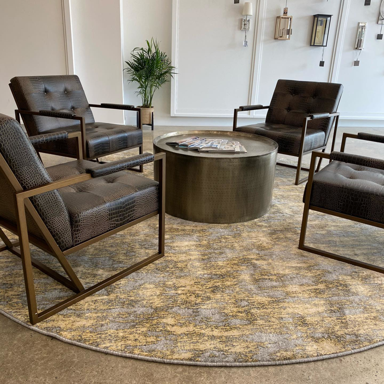 A stylish round area rug complementing lounge seating in a commercial space by CC&S Flooring in Salt Lake City, UT.