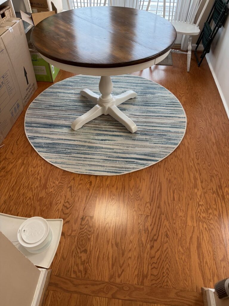 A round, striped area rug under a kitchen table, showcasing work by Advanced Cleaning Systems in Atlanta, GA.