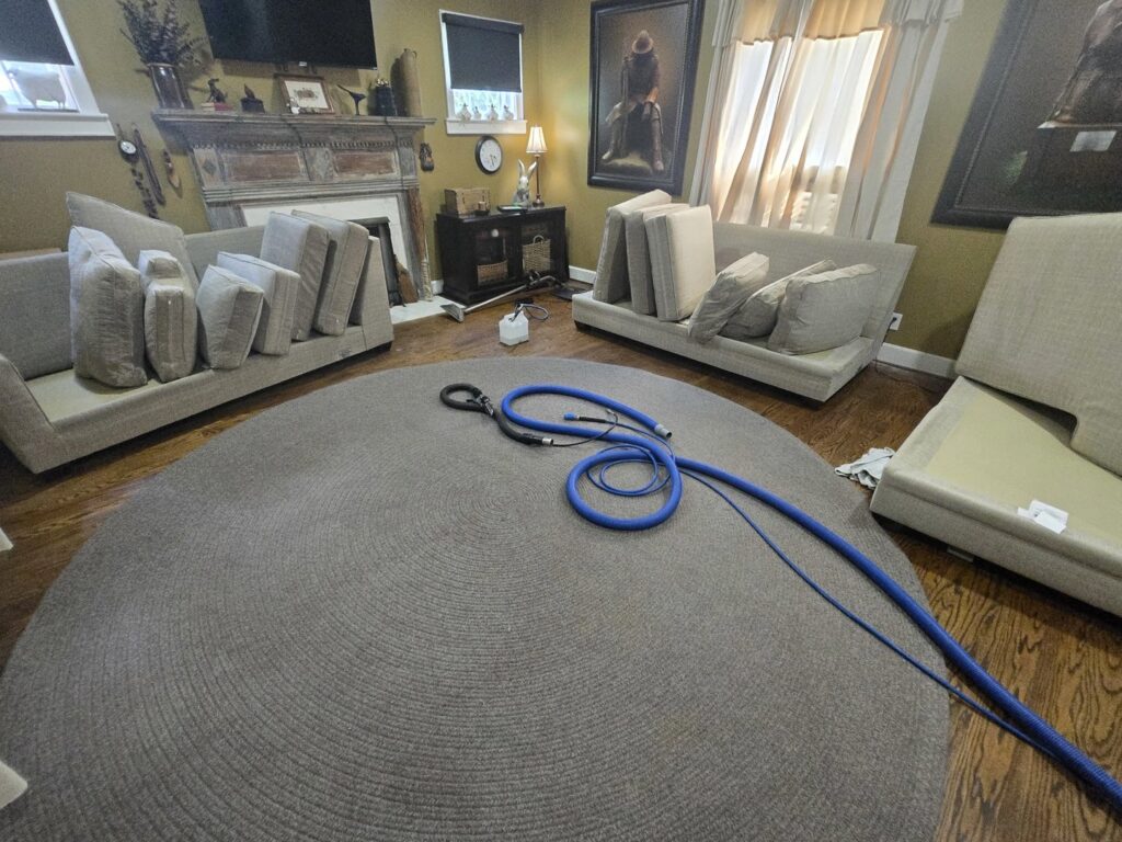 A large round area rug with cleaning hoses, indicating a carpet cleaning job by Pure Steam Carpet Cleaning in Nashville, TN