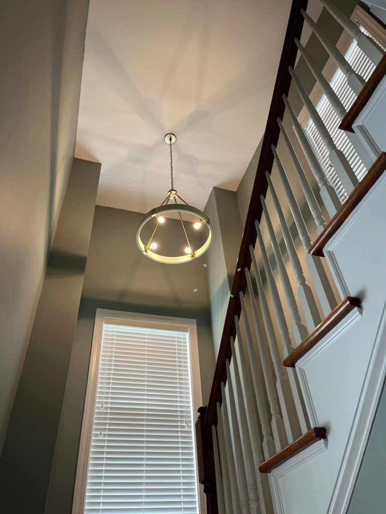 A round chandelier installed in a stairwell by Strother & Son Electric in Mount Pleasant, SC.