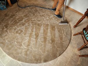 A round floral-patterned area rug being professionally cleaned by LNC Steam Cleaning in Owasso, OK.