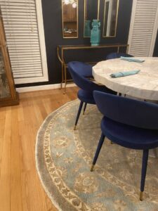 A round oriental rug complementing a modern dining area, provided by J and J Oriental Rug Gallery in Alexandria, VA.