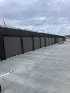 A long row of commercial-style garage doors on a storage facility, installed by Hometown Garage Doors in Crestview, FL.