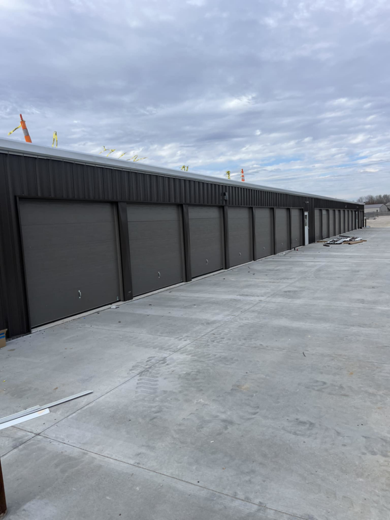 A long row of commercial-style garage doors on a storage facility, installed by Hometown Garage Doors in Crestview, FL.