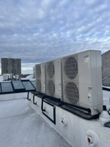 A row of multiple outdoor mini-split condenser units on a commercial rooftop, installed by Hvaclife in Minneapolis, MN.