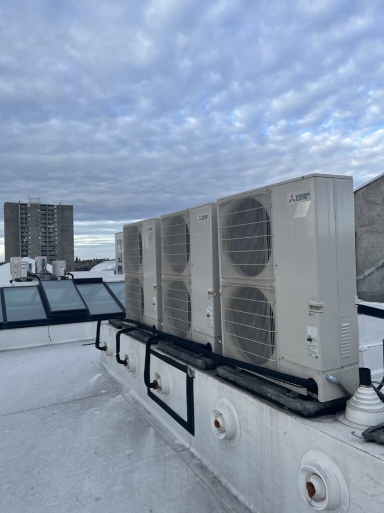 A row of multiple outdoor mini-split condenser units on a commercial rooftop, installed by Hvaclife in Minneapolis, MN.