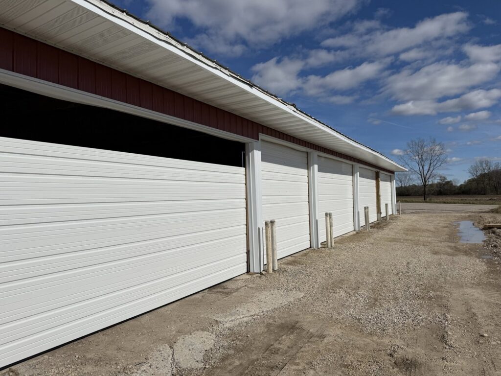 A row of newly installed white commercial or storage unit garage doors by McDonald Overhead Door Inc. in Kenosha, WI.