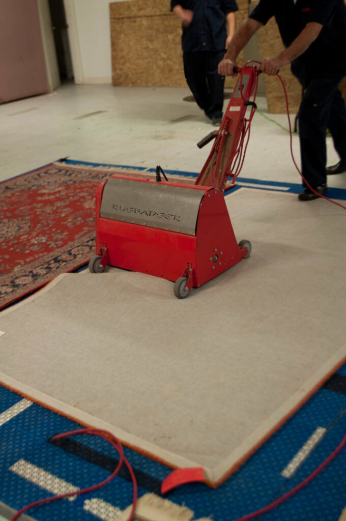 Technicians operating a Rugradger cleaning machine on an area rug at Alameda Carpet & Upholstery Cleaners in Portland, OR.