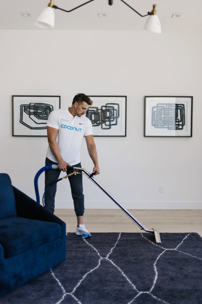 A professional performing a rug cleaning service for a client by Coconut Cleaning of Dallas-Fort Worth in Dallas, TX.